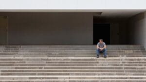 Man sitting alone on steps — meth addiction in Veterans has increased sharply over the past decade